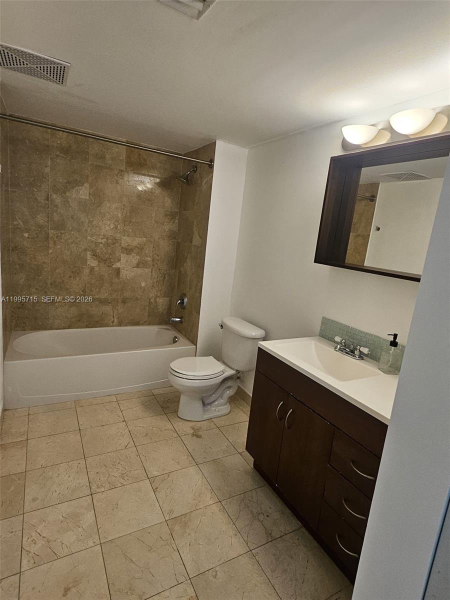 2101 Brickell Avenue, Unit 2111 Miami, FL 33129 - Photo 10 of 16 a bathroom with a sink a toilet and shower