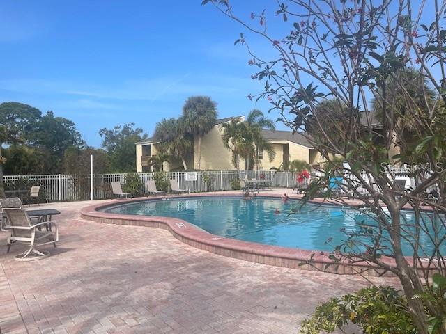 3461 Clark Road, Unit 160 Sarasota, FL 34231 - Photo 21 of 21 a view of a swimming pool with a patio