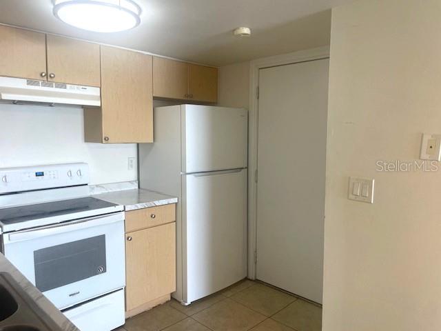 3461 Clark Road, Unit 160 Sarasota, FL 34231 - Photo 7 of 21 a kitchen with a refrigerator sink stove and cabinets