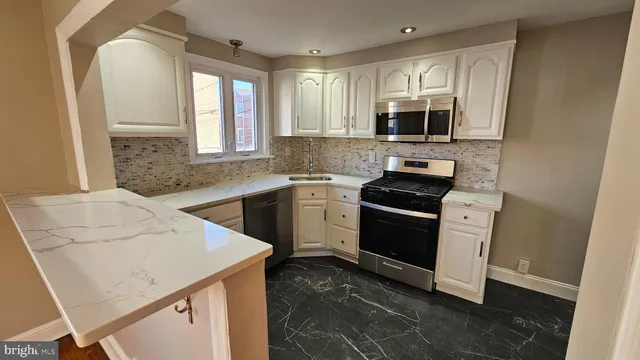 a kitchen with a sink stove and microwave