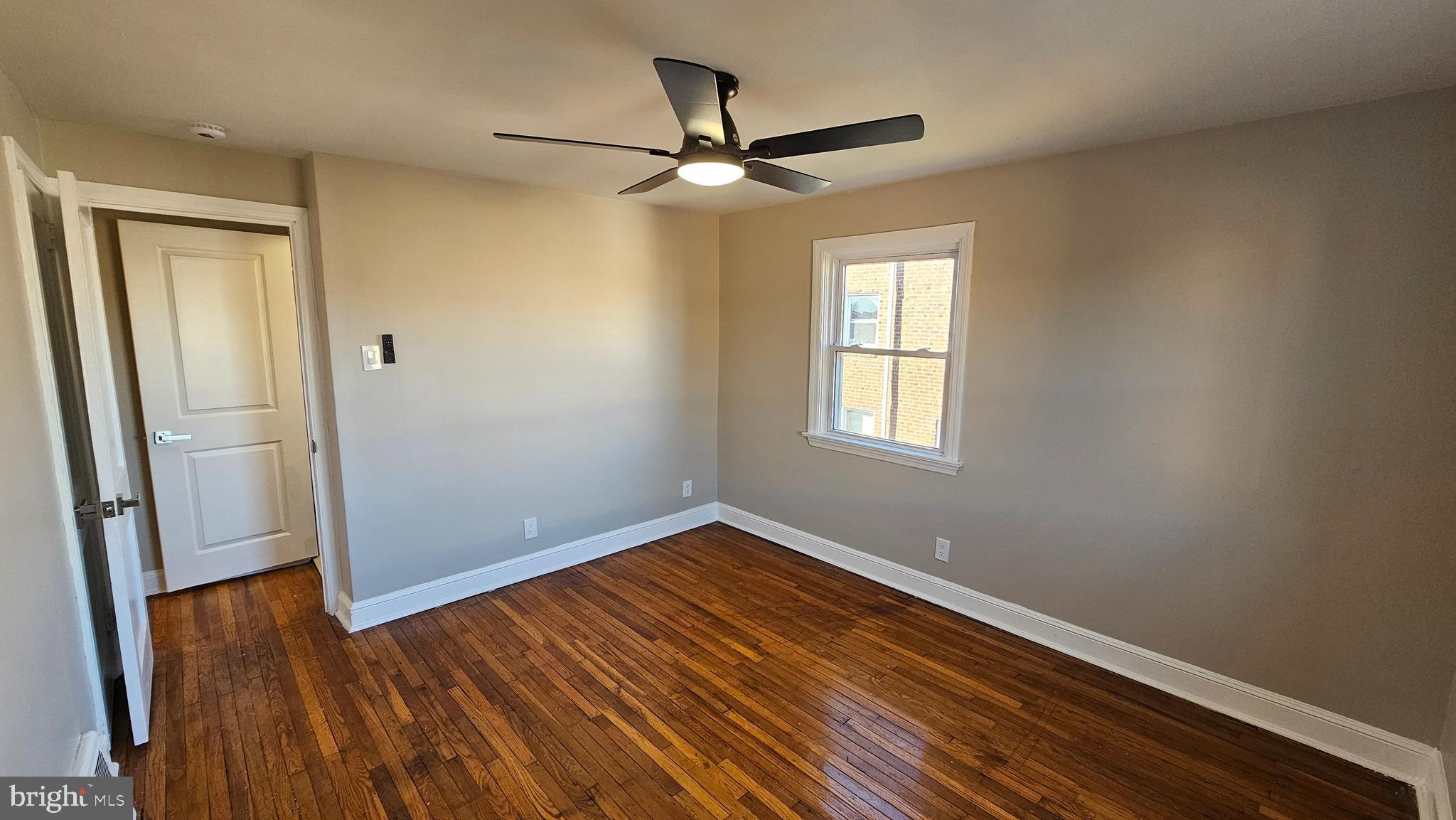 825 Laurel Road Lansdowne, PA 19050 - Photo 22 of 35 an empty room with wooden floor fan and windows