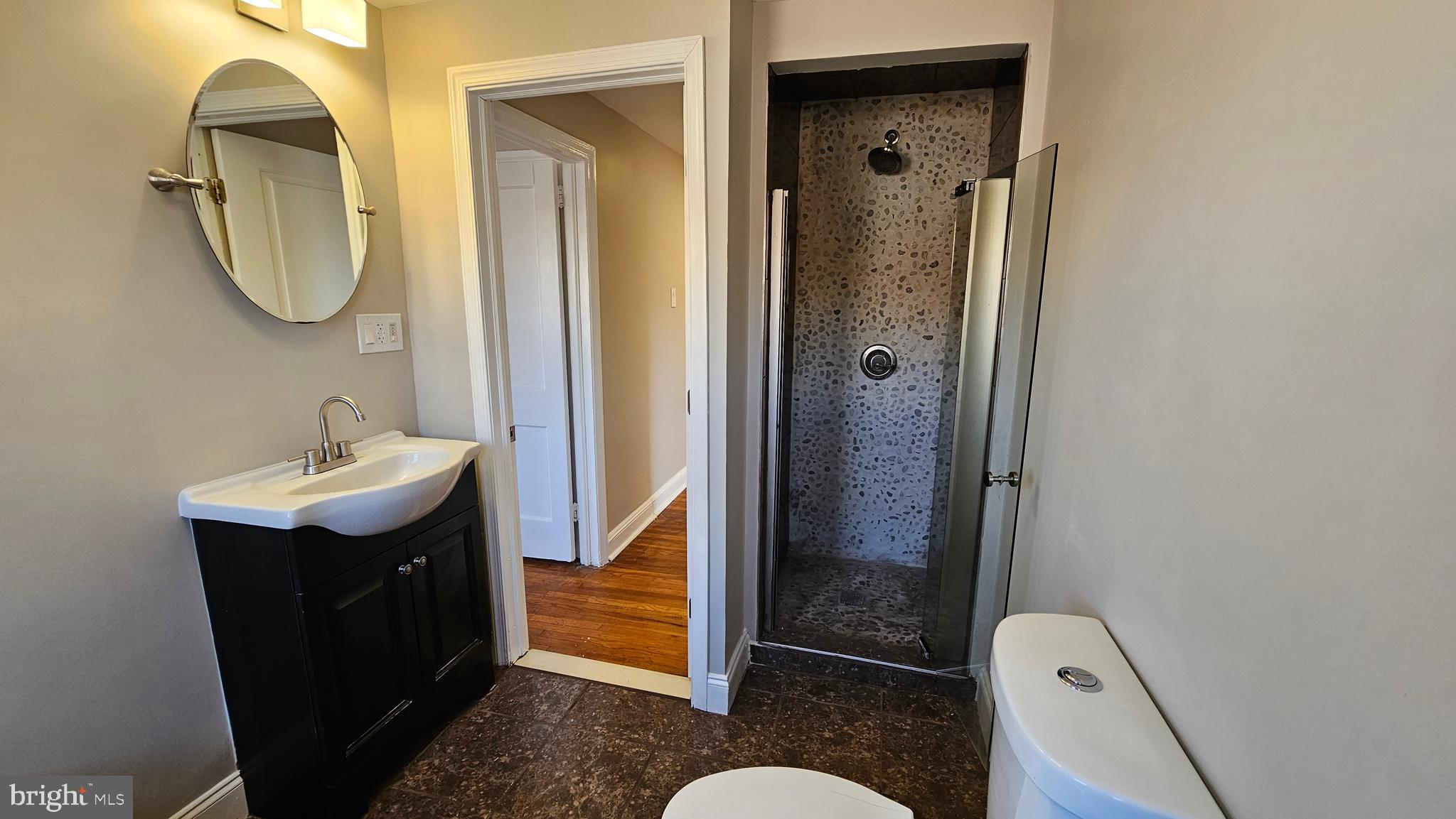 825 Laurel Road Lansdowne, PA 19050 - Photo 26 of 35 a bathroom with a sink a mirror a toilet and shower