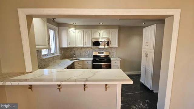 a kitchen with a sink a stove and cabinets