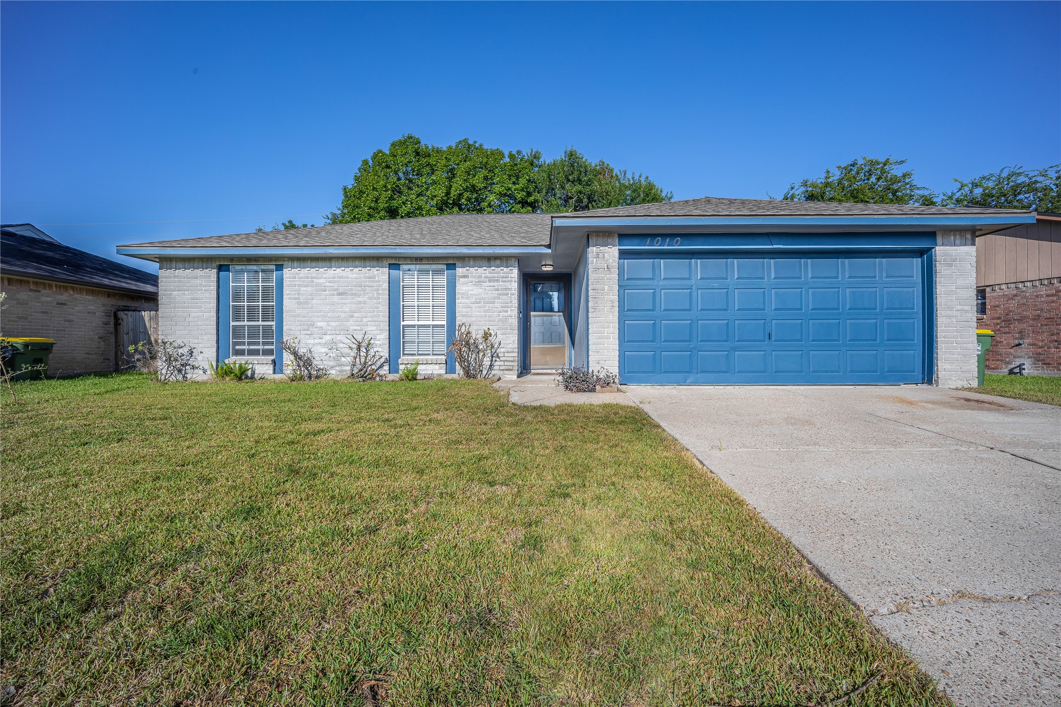 1010 Woodbridge Avenue Pearland, TX 77584 - Photo 2 of 14 a view of a house with a yard and garage