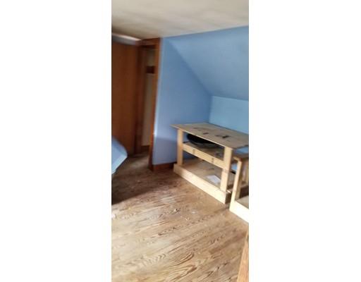 34 Manning Road Chelmsford, MA 01824 - Photo 23 of 30 a living room with a chair and a refrigerator
