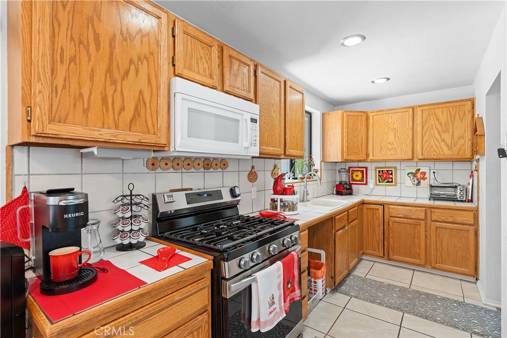 1876 Sparrow Road Wrightwood, CA 92397 - Photo 11 of 31 a kitchen with a stove a sink and cabinets