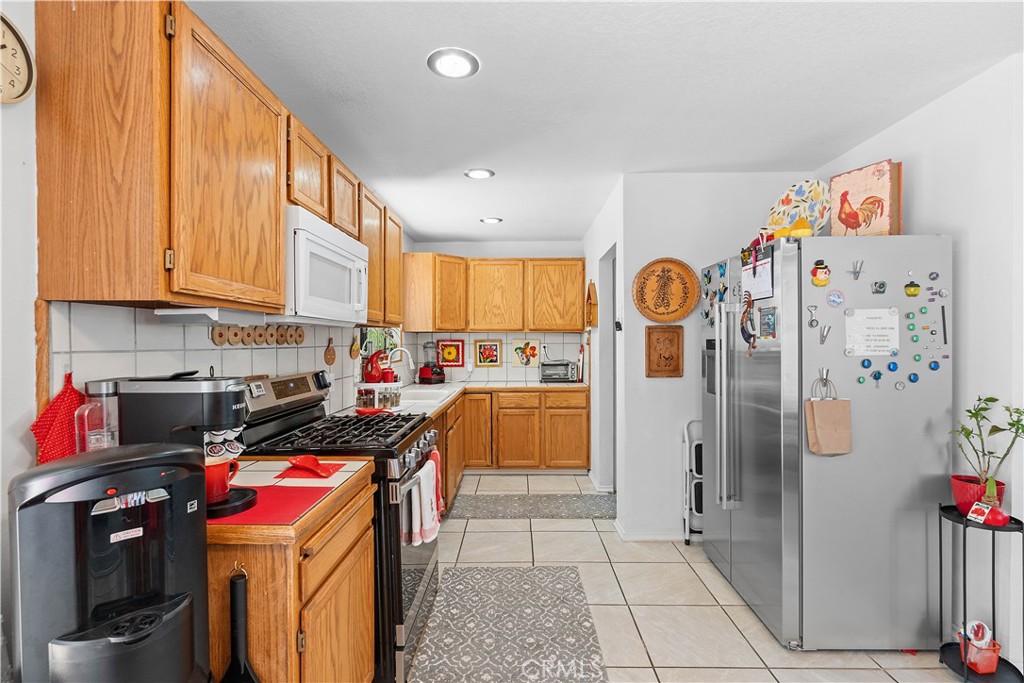 1876 Sparrow Road Wrightwood, CA 92397 - Photo 12 of 31 a kitchen with stainless steel appliances granite countertop a stove a refrigerator and cabinets