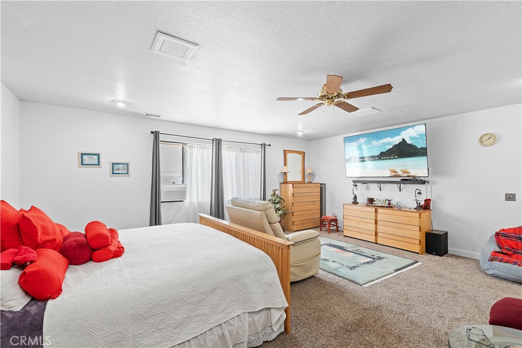 1876 Sparrow Road Wrightwood, CA 92397 - Photo 18 of 31 a bedroom with a bed and wooden floor