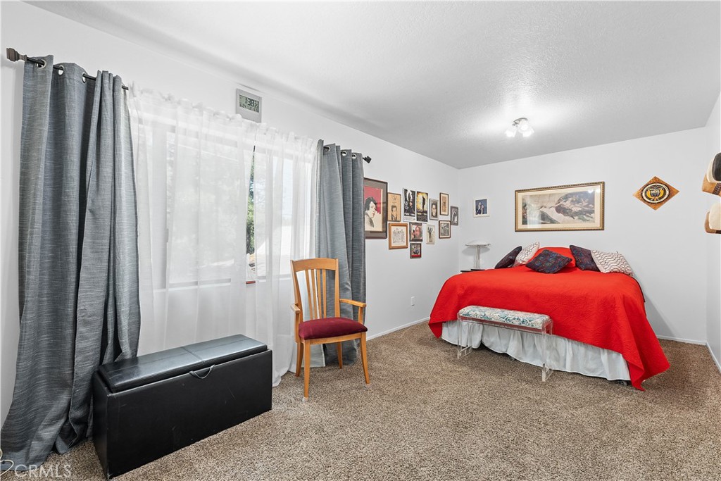 1876 Sparrow Road Wrightwood, CA 92397 - Photo 22 of 31 a bedroom with a bed and a walk in closet with window