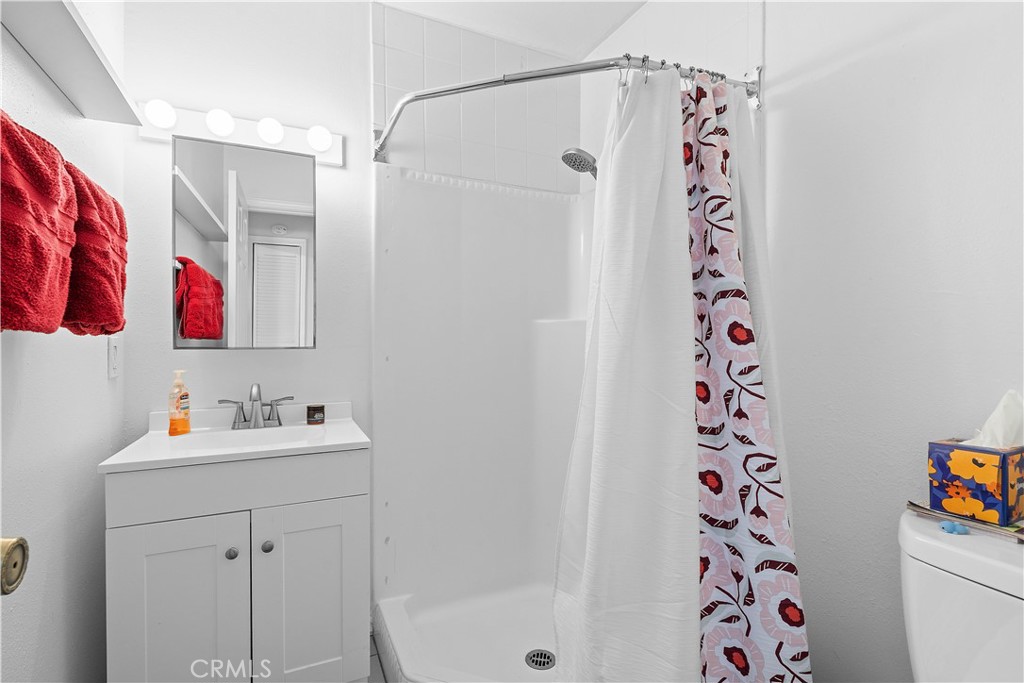 1876 Sparrow Road Wrightwood, CA 92397 - Photo 26 of 31 a bathroom with a sink and a shower curtain