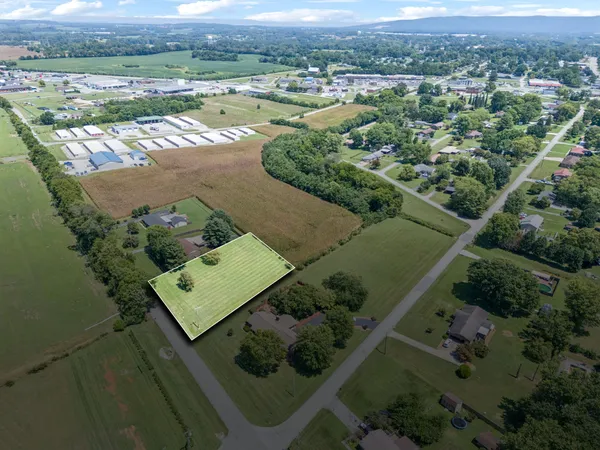 an aerial view of a houses with a yard