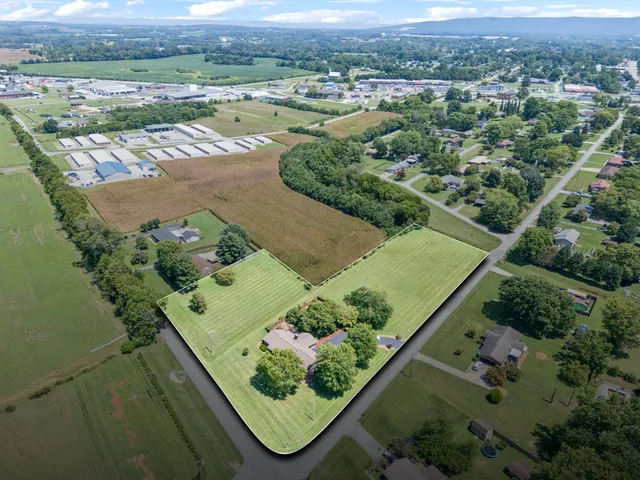 an aerial view of a residential houses with outdoor space