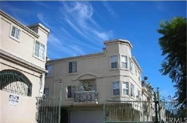 4516 Ramsdell Avenue, Unit 106 La Crescenta, CA 91214 - Photo 1 of 1 a view of a white building among the street with palm trees
