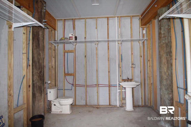 12900 Honey Rd Extension Summerdale, AL 36580 - Photo 6 of 44 Huge store room under house with 2 piece bathroom and stubbed for washer, dryer, fridge and/or freezer. Numerous opportunities for this space