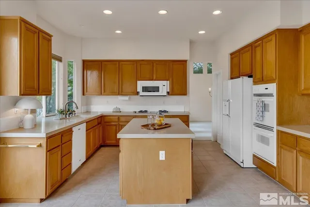 a kitchen with stainless steel appliances a stove a sink and a refrigerator