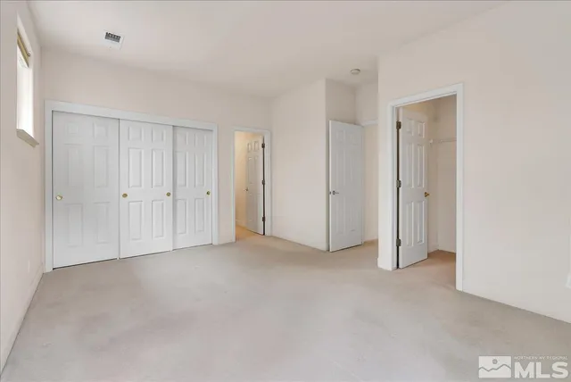 a spacious bathroom with a tub double sink window and mirror