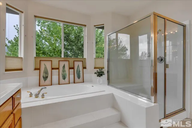 a bathroom with a tub shower and sink