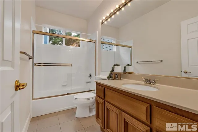 a white toilet sitting next to a bath tub