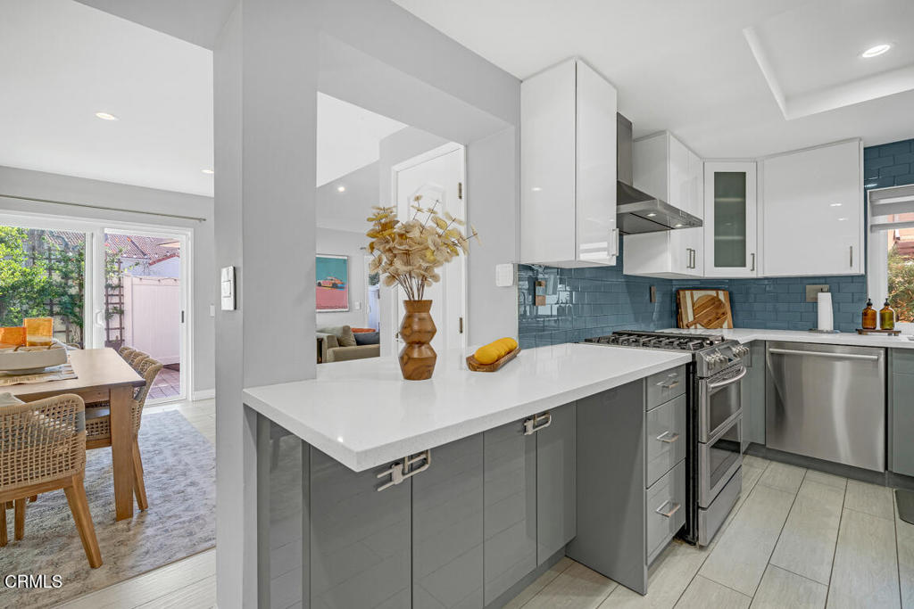 6301 Honolulu Avenue, Unit 47 Tujunga, CA 91042 - Photo 12 of 40 a kitchen with a sink a stove and chairs