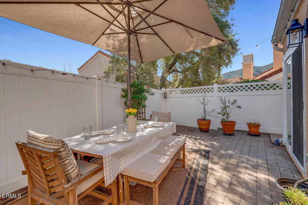 6301 Honolulu Avenue, Unit 47 Tujunga, CA 91042 - Photo 29 of 40 a roof deck with table and chairs under an umbrella