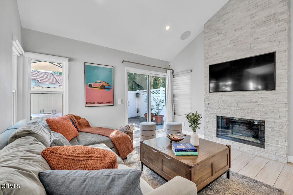 6301 Honolulu Avenue, Unit 47 Tujunga, CA 91042 - Photo 8 of 40 a living room with furniture a flat screen tv and a fireplace