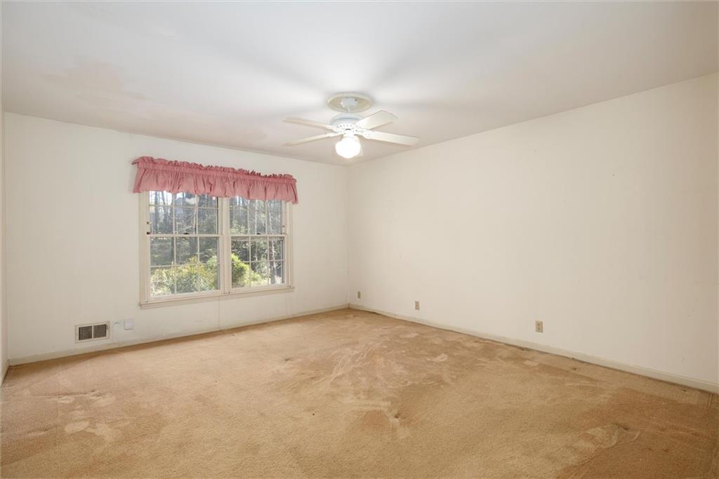5416 Pheasant Run Smoke Rise, GA 30087 - Photo 16 of 47 an empty room with a window and a fan