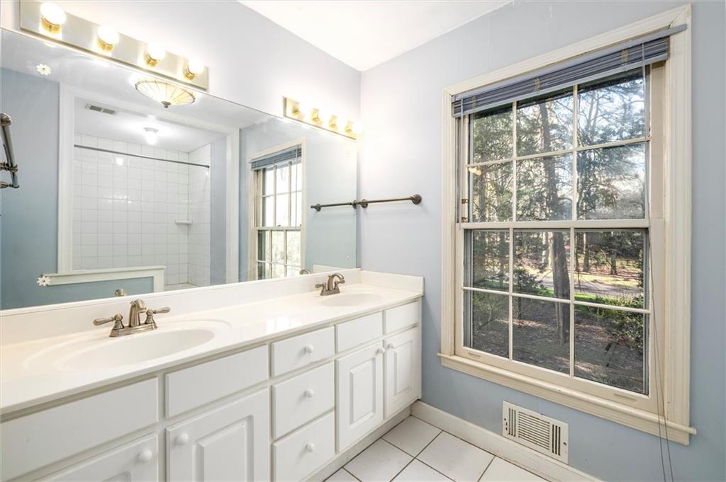 5416 Pheasant Run Smoke Rise, GA 30087 - Photo 21 of 47 a bathroom with a sink vanity and a mirror