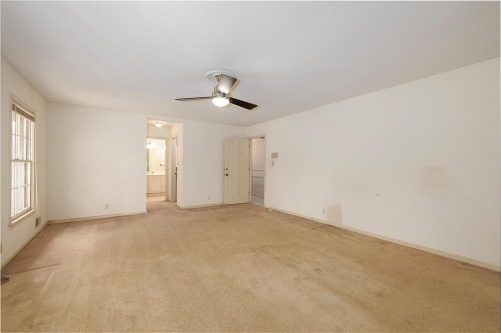 5416 Pheasant Run Smoke Rise, GA 30087 - Photo 23 of 47 an empty room with windows and ceiling fan view