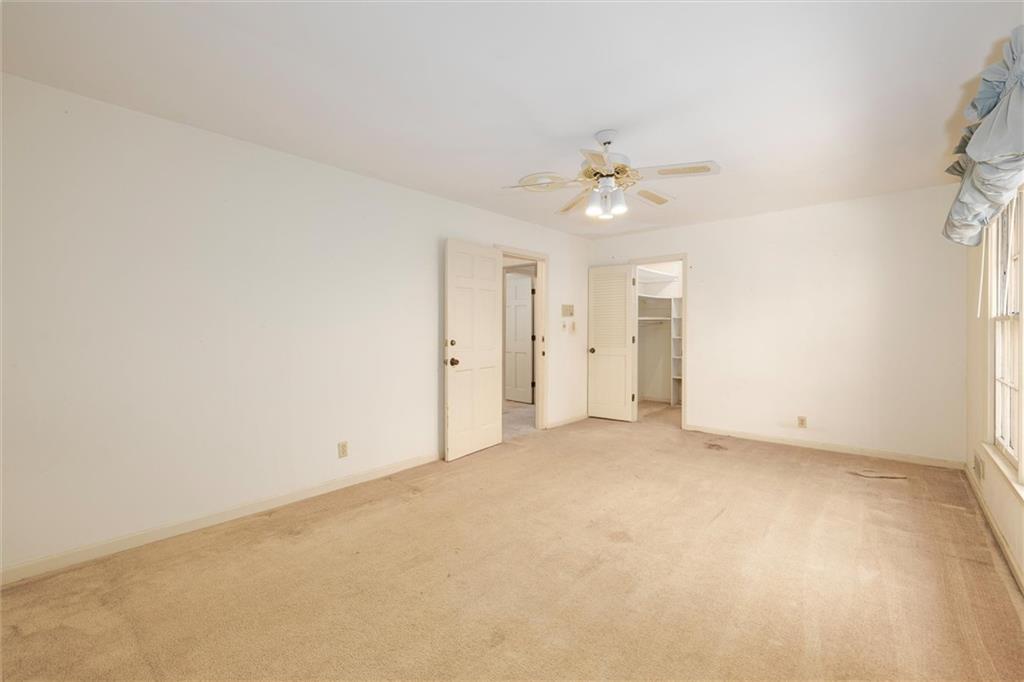 5416 Pheasant Run Smoke Rise, GA 30087 - Photo 25 of 47 an empty room with a ceiling fan and a window