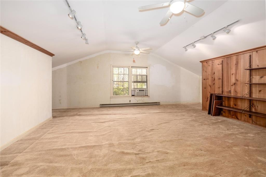 5416 Pheasant Run Smoke Rise, GA 30087 - Photo 27 of 47 en empty room with windows and ceiling fan
