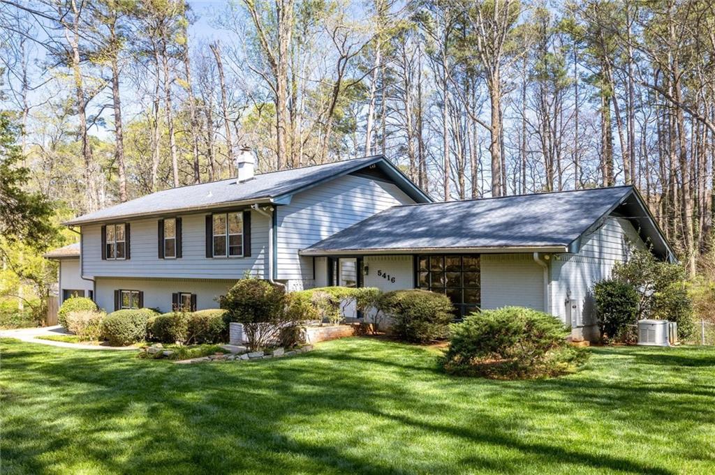 5416 Pheasant Run Smoke Rise, GA 30087 - Photo 5 of 47 a front view of a house with a garden