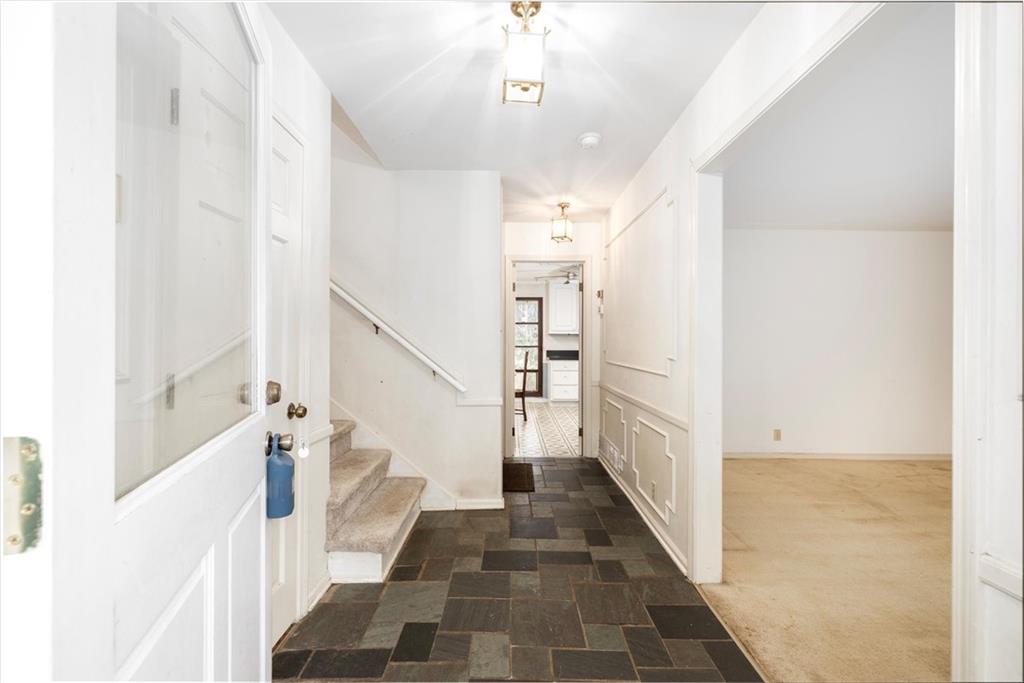 5416 Pheasant Run Smoke Rise, GA 30087 - Photo 7 of 47 a view of a hallway with a white walls and stairs