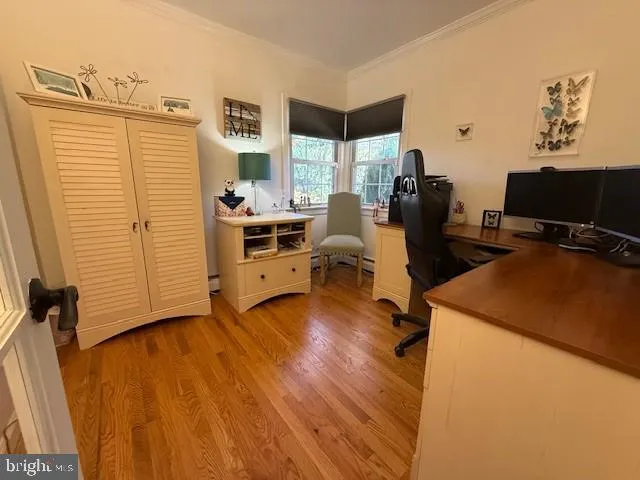 a view of a workspace with furniture and a window