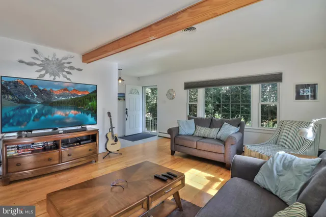 a living room with furniture and a floor to ceiling window