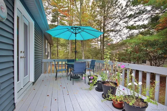 a view of balcony with outdoor seating and wooden floor