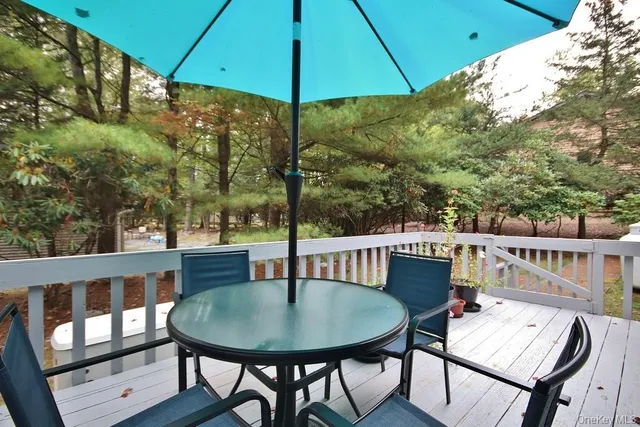 a view of balcony with furniture and umbrella