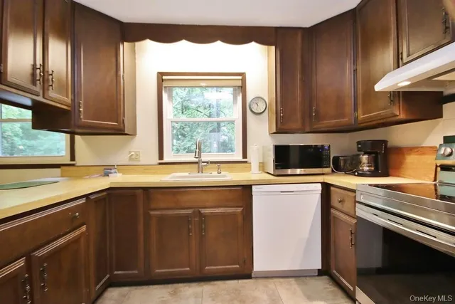 a kitchen with a sink stove and cabinets