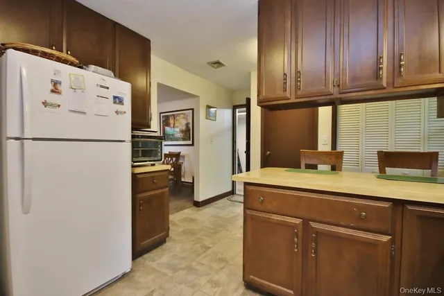 a white refrigerator freezer sitting inside of a kitchen