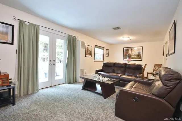 a living room with furniture a large window and a flat screen tv