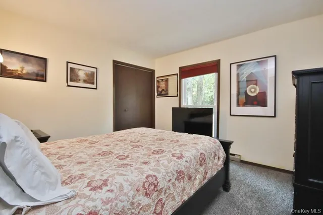 a bedroom with a large bed and a window