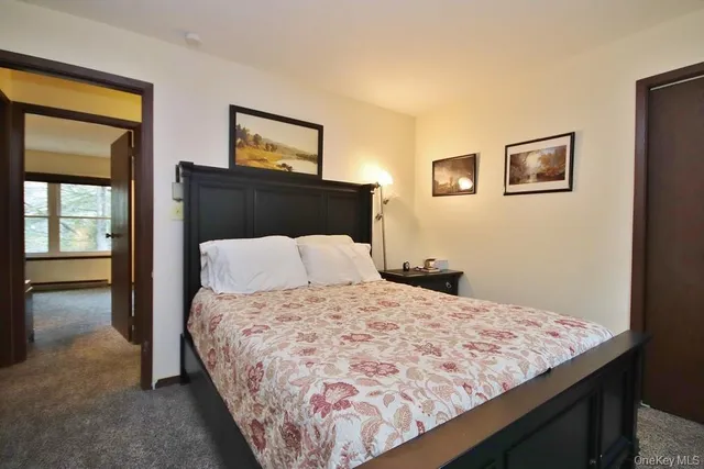 a bedroom with a bed and painting on the wall