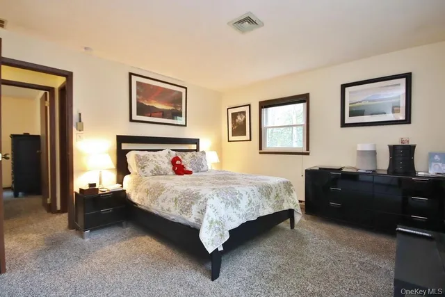 a bedroom with a bed and a desk