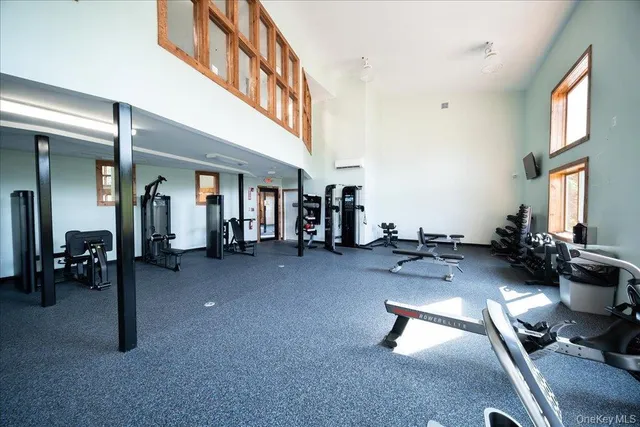 a gym room with gym equipment and a large window