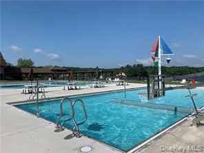 a swimming pool with chairs