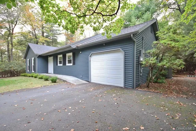 a view of a house with a yard and garage