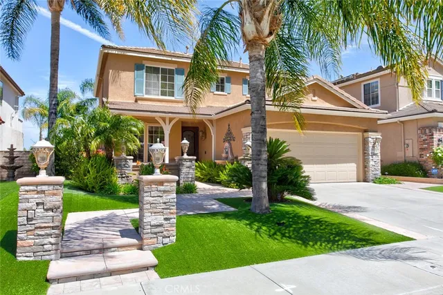 a front view of a house with a garden and plants