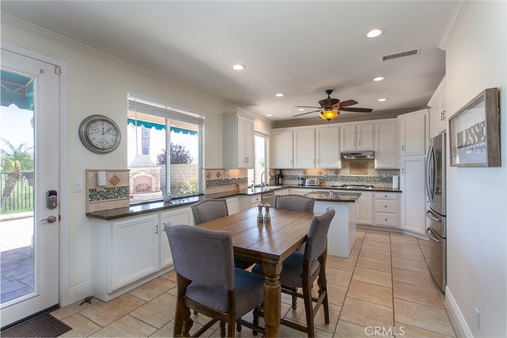 26211 Reade Place Stevenson Ranch, CA 91381 - Photo 12 of 42 a kitchen with a table and chairs in it