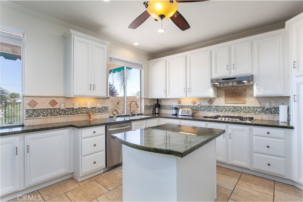 26211 Reade Place Stevenson Ranch, CA 91381 - Photo 13 of 42 a kitchen with granite countertop a sink and cabinets