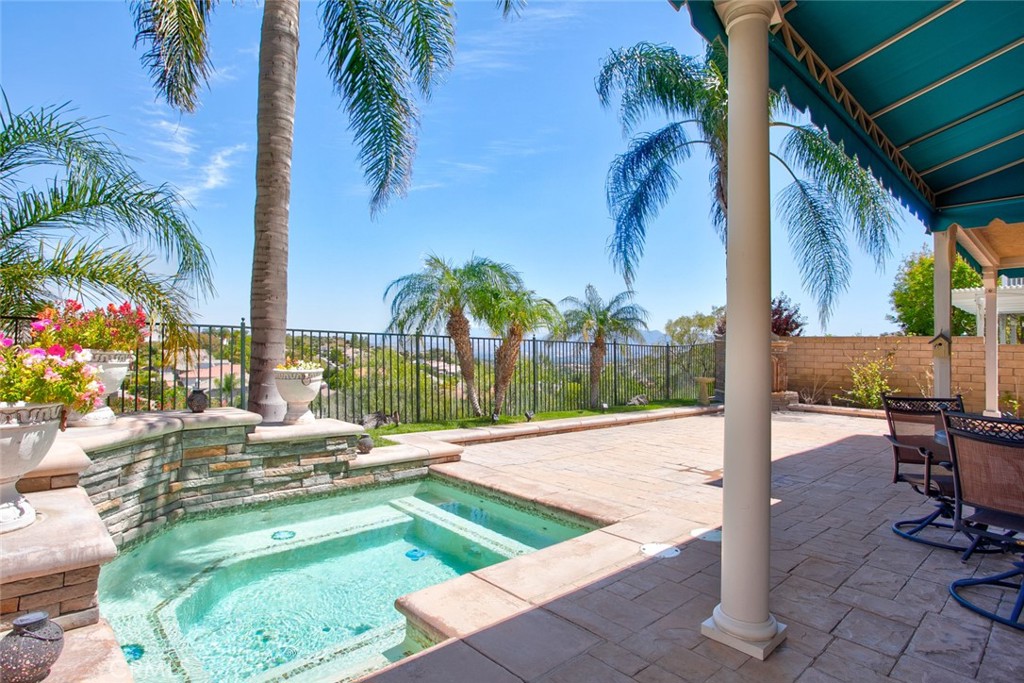 26211 Reade Place Stevenson Ranch, CA 91381 - Photo 24 of 42 a view of a swimming pool with a lounge chairs