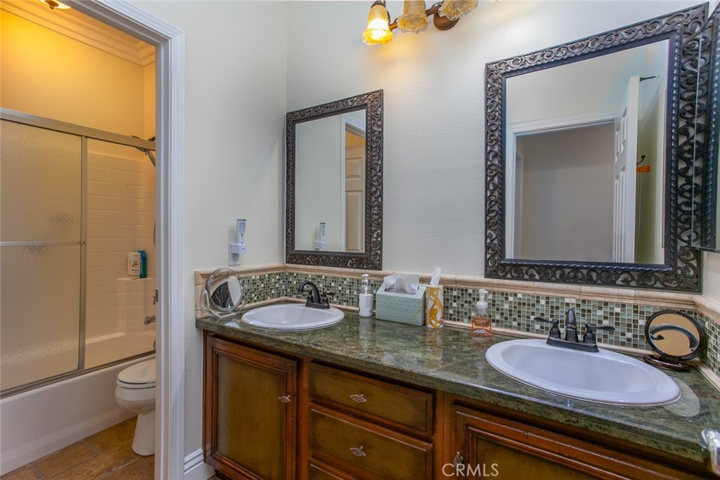 26211 Reade Place Stevenson Ranch, CA 91381 - Photo 34 of 42 a bathroom with a granite countertop sink and a mirror